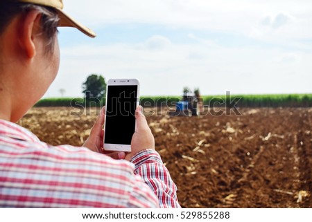 Farmers use mobile phones on the farm. /Selective focus.