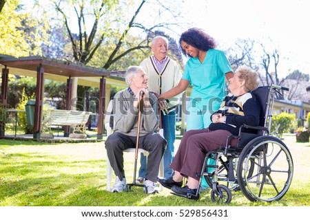 Rehabilitation clinic with elderly people and nurse. Royalty-Free Stock Photo #529856431
