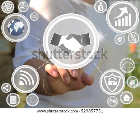 Businesswoman pressing handshake button on virtual screens. Conclusion of the transaction of business. Business community .