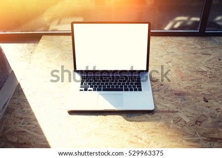 Close up of modern laptop computer on home desktop, downloading testing program software connected to fast 4G internet with copy space on mock up display for your advertising messages or text