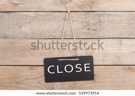Signboard with text "Close" on wooden background