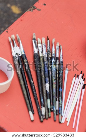 paints and brushes used to paint a picture