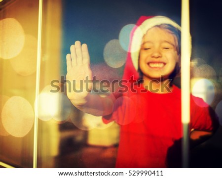 Little boy on winter window looking outside and waiting for winter holidays happy moments and fun (noise added for the effect)