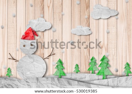 Christmas Background, Snowman wearing red Santa hat in winter with snow, paper cut made of crumpled paper, on wood texture background