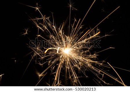 Burning sparklers isolated on black background
