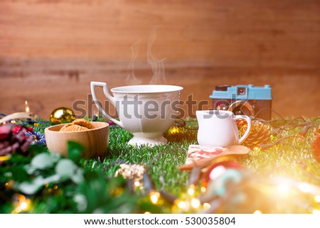 Coffee Break and mini cookies in Christmas day on green grass. Morning sunshine day and good day. Happy time together in winter season.