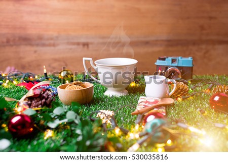 Coffee Break and mini cookies in Christmas day on green grass. Morning sunshine day and good day. Happy time together in winter season.