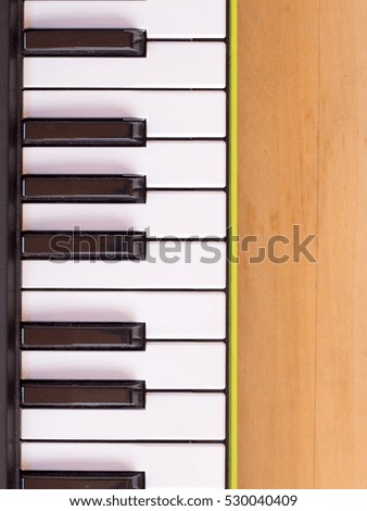 Keyboard of mini digital piano on wooden table