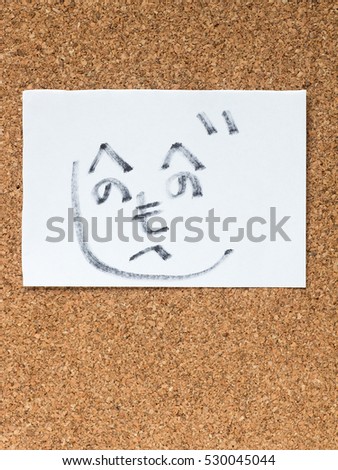 The series of Japanese emoticons called Kaomoji on the cork board, guy