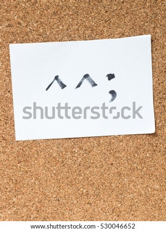 The series of Japanese emoticons called Kaomoji on the cork board, awkward