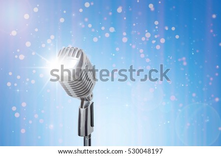 Retro microphone over the Abstract photo of christmas and blurred background, vintage musical concept
