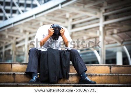 Business man who lost job abandoned lost in depression sitting on the subway stair suffering emotional pain. Businessman who have trouble with his job.Portrait of unhappy man under depression. Royalty-Free Stock Photo #530069935