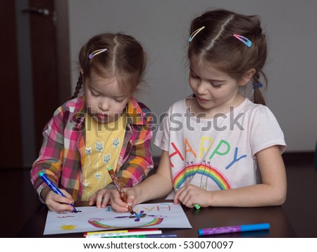 Happy cute kids draw rainbows and write the word happiness