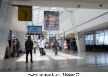 Blur background. Airport scene. People walking out of  focus. Busy