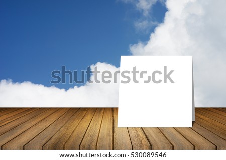 White card put on wooden desk or wooden floor on blue sky and cloud background.use for present or mock up your product.product display template.Business presentation.clipping path include