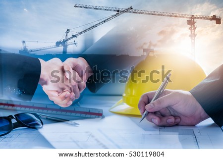Double exposure of construction site and Business people shaking hands after the contract is signed for construction management Infrastructure plan guidelines concept.