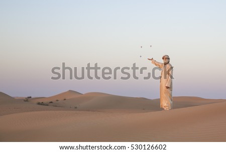 Man in traditional outfit in a desert at sunrise near Dubai