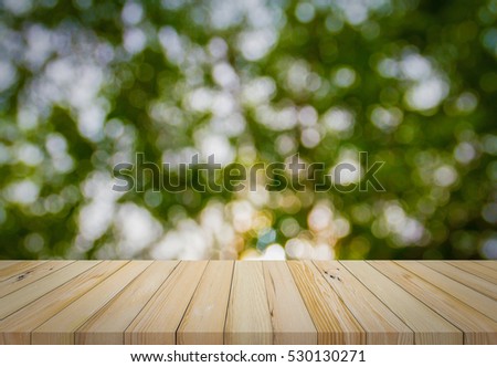 Wood plank with abstract natural green blurred bokeh background for product display 
