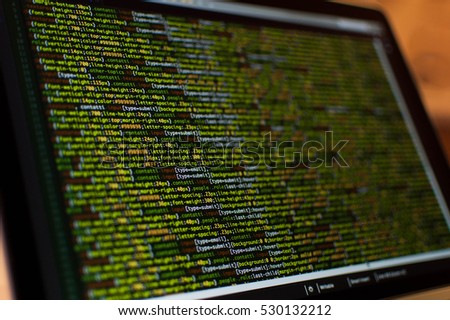 Software development. Software source code. Programming code. Writing programming code on laptop.