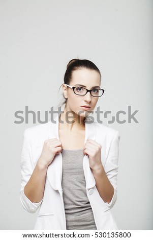 Business woman, white suit and glasses.