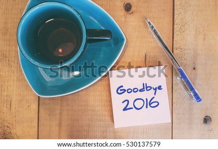 Goodbye 2016 - handwriting on paper with cup of tea and pen.