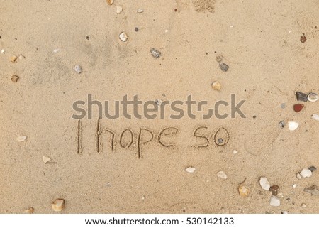 written words "I hope so" on sand of beach