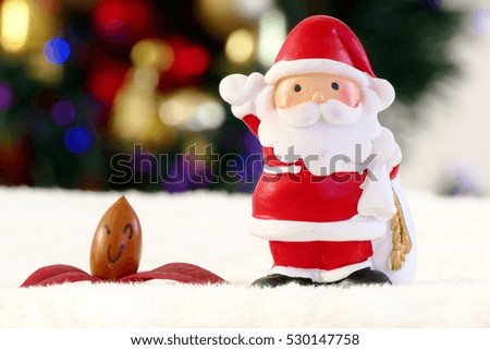Close-up Santa Clause and smiley acorn and maple leaf  with the blurred background of Decorated Christmas tree