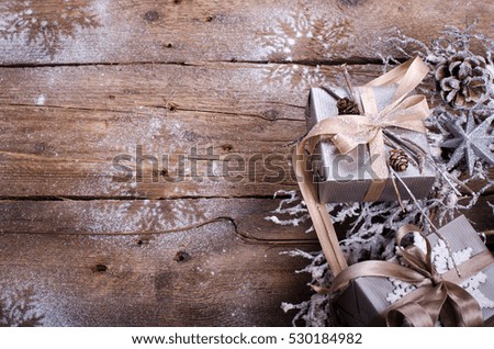 Rustic Christmas wreath with gifts on wooden background. Free space for your text.