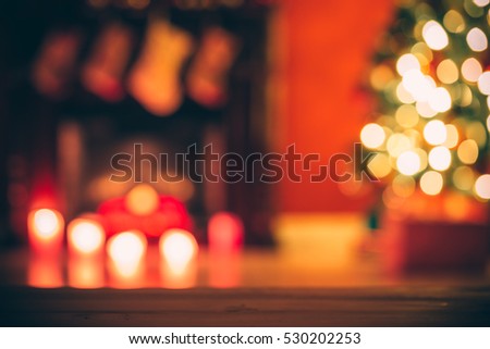 Beautiful  Defocused background new year room with decorated Christmas tree, gifts and fireplace with the glowing lights at night. The idea for postcards. Soft focus. Shallow DOF.