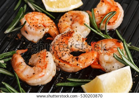 Grilled tiger shrimps with spice and lemon. Grilled seafood. Royalty-Free Stock Photo #530203870