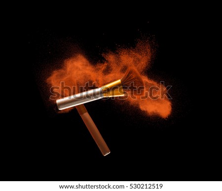 Makeup brushes with powder splash isolated on black background