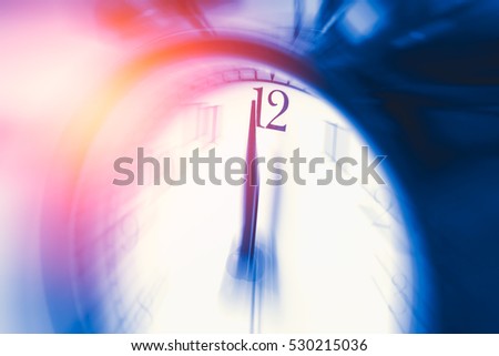 clock time with zoom motion blur focus at 12 o'clock, fast speed business hour concept. Royalty-Free Stock Photo #530215036