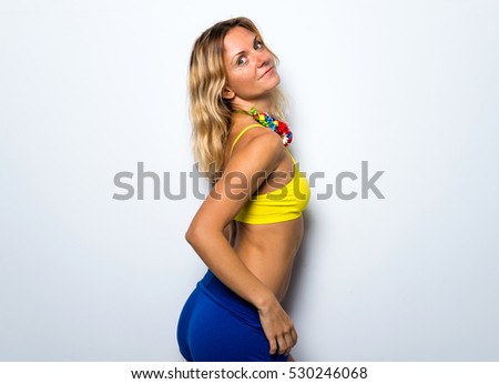 Cute model woman posing in studio with a colorful flower necklace