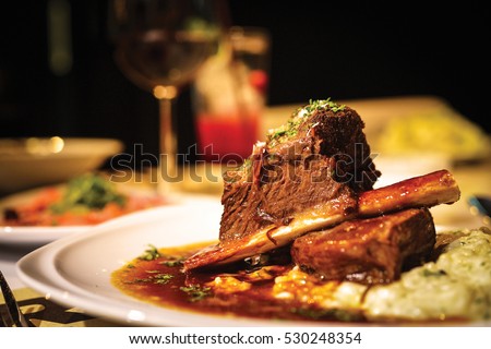 Close up of braised beef short rib on dinner table. Selective focus.
 Royalty-Free Stock Photo #530248354