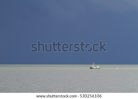 Fishingboat at see with storm.