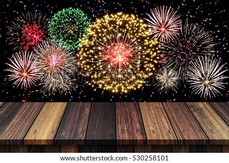 Abstract empty wooden floor with fireworks background. colorful fireworks over dark sky abstract for background. New Year celebration fireworks.