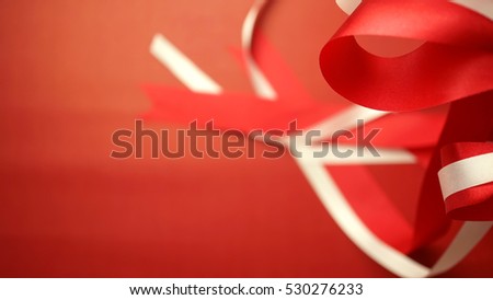 red and white ribbons in blurred style on craft paper for christmas and new year background