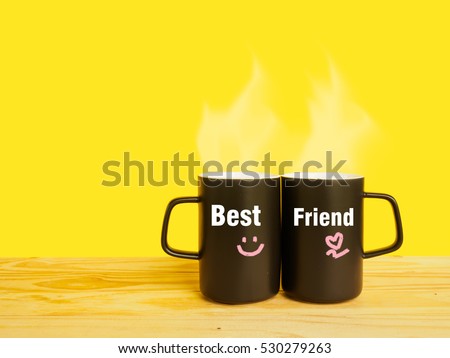 Best friend message on couple coffee or tea cup on desk of yellow background