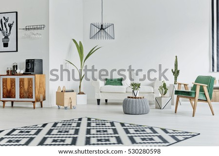 Spacious white room with pattern carpet, sofa and armchair Royalty-Free Stock Photo #530280598
