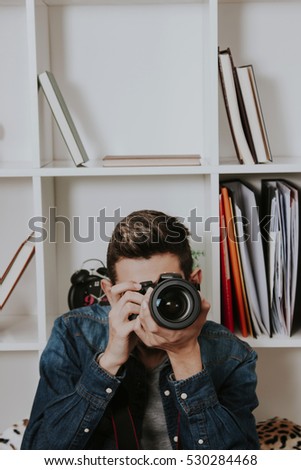young male photographer with the digital SLR camera