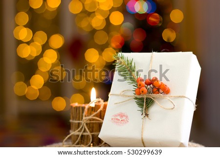 Handmade candles and gift. Christmas decorations. Candle of cinnamon and bow made of jute. Bokeh.