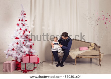family, children, christmas, x-mas, love concept - happy father with adorable baby daughter near christmas tree