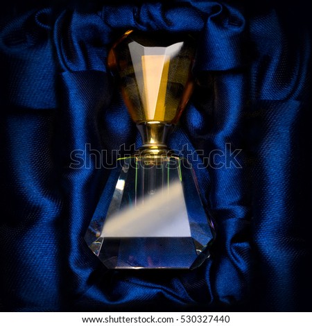 bottle of perfume on a dark blue background