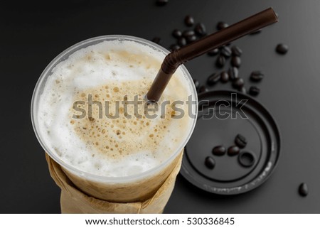 Iced latte coffee with coffee beans in top view