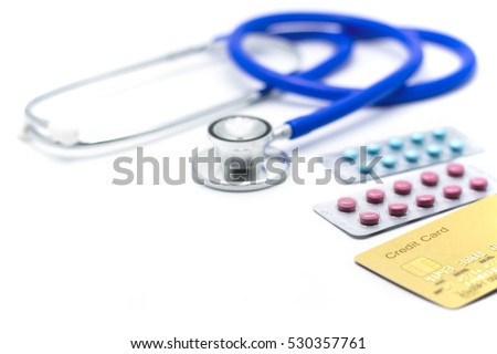 Golden credit card with medical stethoscope and blisters of pills on white background. Medical cost concept.