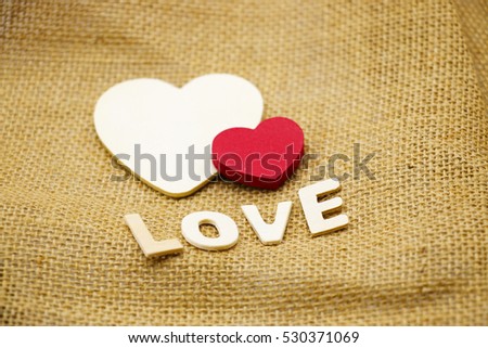 Wooden heart on brown background
