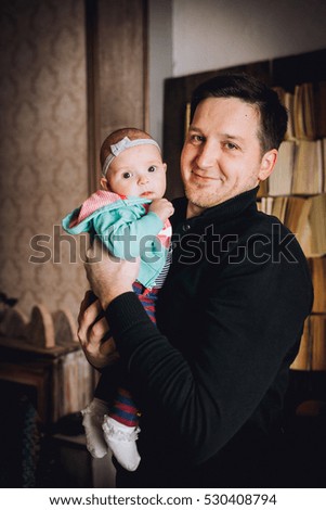 Young father and his baby in interior studio. Christmas photo.