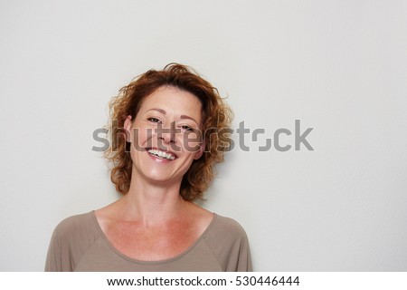 Close up portrait of smiling brunette woman on white background Royalty-Free Stock Photo #530446444