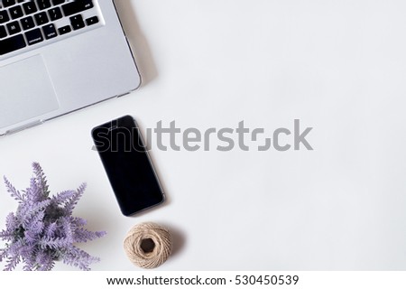 White office desk table with laptop, smartphone, rope, and lavender. Top view with copy space, flat lay.