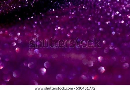 glitter vintage lights background. purple and black. defocused.
